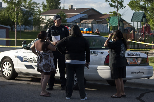 Chris Detrick  |  The Salt Lake Tribune 
Unified Police investigate the scene of a shooting Tuesday at Mountain Man Park in Kearns. One victim was shot in his leg near 4900 South Heath Avenue (5150 West).