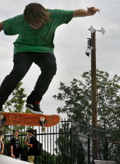 Scott Sommerdorf  |  The Salt Lake Tribune
Skateboarder Sterling Williams jumps and does a trick at the Taylorsville Skatepark at 4800 S. Redwood Road under the watchful eye of the camera on the pole in the background, Friday, July 8, 2011. Taylorsville has had cameras in its parks since late 2008.