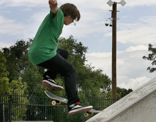 Scott Sommerdorf  |  The Salt Lake Tribune
Skateboarder Sterling Williams jumps and does a trick at the Taylorsville Skatepark at 4800 S., Redwood Road under the watchful eye of the camera on the pole in the background, Friday, July 8, 2011. Taylorsville has had cameras in its parks since late 2008.