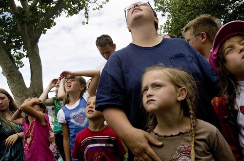 Djamila Grossman  |  The Salt Lake Tribune

Susie Summers and her daughters Savannah, 5, left, and Sariah, 7, watch as workers put up a statue of the angel Moroni atop the new Brigham City Temple of The Church of Jesus Christ of Latter-day Saints on Tuesday, July 12, 2011.