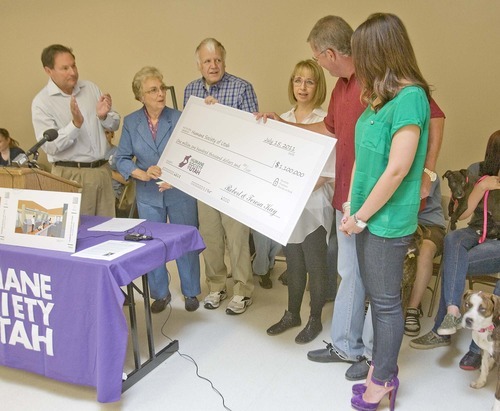Paul Fraughton  |  The Salt Lake Tribune

Robert and Teresa Kay, with their daughter Linzi, far right, pass a $1.1 million check to Gene Barierschmidt, left, executive director of the Humane Society of Utah, Midvale Mayor JoAnne Seghini and Craig Cook, chairman of the society's board.