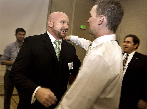 Scott Sommerdorf  |  The Salt Lake Tribune
Brian Doughty turns to hug his partner, Rian Davis, right, on Saturday after having been announced as the winner in the District 30 race for Jackie Biskupski's House seat. Rep. Brian S. King, D-Salt Lake, is at far right.