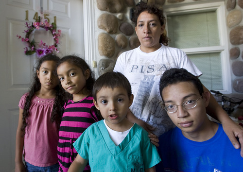 Al Hartmann  |  The Salt Lake Tribune
Maribel Melgar poses with her children, twins Cindy and Diane, 7, left, Andy, 4, and Hans, 16, at their Orem home.      Husband and father Rogelio Melgar was arrested by immigration for allegedly using a fake ID to work in the country illegally.