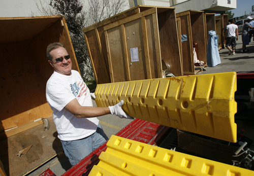 Francisco Kjolseth  |  The Salt Lake Tribune
Gary Gilgen, of Taylorsville, loads up the items found in the storage unit of his winning bid during a recent auctions at A-1 Pioneer Moving & Storage in North Salt Lake on July 2. A few dozen people showed up to bid on six storage containers with a number of items containing such random items as film reels, furniture, tools and wire covers.
