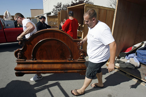 Francisco Kjolseth  |  The Salt Lake Tribune
Chase Wiley, left, and friend Kameron Rollins, of Provo, do pretty well during a recent storage unit auction as they unload an ornate bed after landing a winning bid on two units at A-1 Pioneer Storage in North Salt Lake on July 2. The belongings of someone who has defaulted on their storage units could contain valuable items or things bound for the dump as people are only allowed to peek in and take a gamble on the value of what they can see.