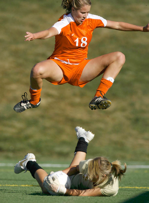 Trent Nelson  |  The Salt Lake Tribune
Brighton's Kassidy Kellogg leaps over Davis goalkeeper Danielle MacKay on Oct. 19.