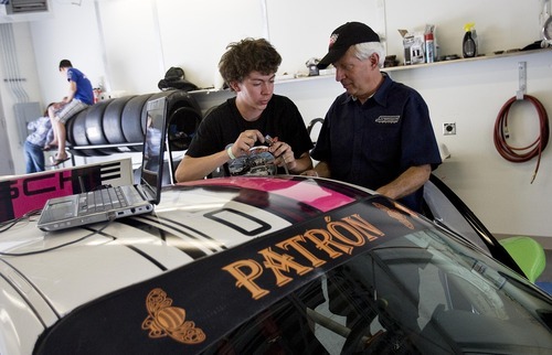 Djamila Grossman  |  The Salt Lake Tribune

Madison Snow, 15, talks to his dad, Martin Snow, as he gets his car ready for a race at the Miller Motorsports Park in Tooele on Sunday, July 17, 2011. Madison grew up in a successful racing family and has been winning a lot of races.