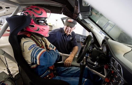 Djamila Grossman  |  The Salt Lake Tribune

Madison Snow, 15, talks to his dad, Martin Snow, as he gets ready for a race at the Miller Motorsports Park in Tooele on Sunday, July 17, 2011. Madison grew up in a successful racing family and has been winning a lot of races.