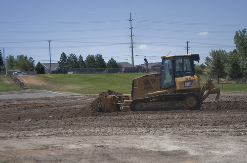 Margaret Distler  |  The Salt Lake Tribune

A construction worker moves dirt at the site of the future Mountview Park at 1651 E. Fort Union Blvd on Friday, July 15, 2011. The new park, according to its final concept plan, will include tennis and basketball courts, splash pads, playgrounds, two multi-use playfields, among several other features.