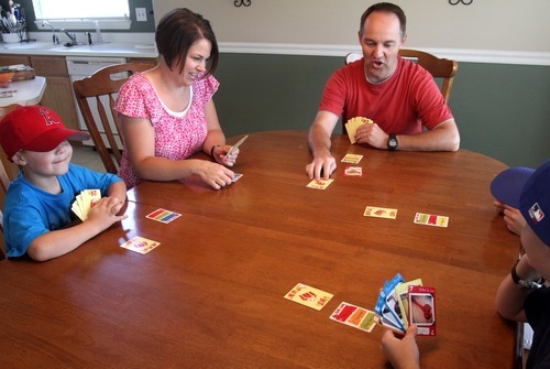 Rick Egan   |  The Salt Lake Tribune
The Kelley Family, from left, Daniel, Amy, Brian, Amanda and Trevor, play the White Elephant card game at their Riverton home, where Brian created the game and is raising money online to develop it through a website called Kickstarter.