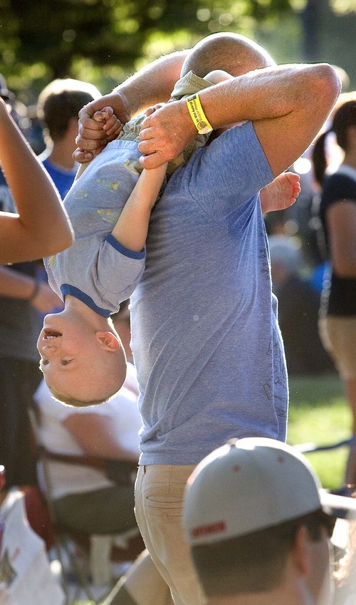 Paul Fraughton  |  The Salt Lake Tribune
While waiting for the concert to begin, Finn House, 2, has some fun with his dad, Dave House, at the Twilight Concert Series at Pioneer Park in Salt Lake City on Thursday,  July 21, 2011.