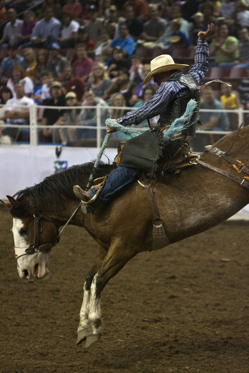 Chris Detrick | The Salt Lake Tribune 
Kurtis Koeppen, of Challis, Idaho, competes in the saddle bronc riding competition during the Days of '47 Rodeo at the Maverik Center Thursday July 21, 2011.