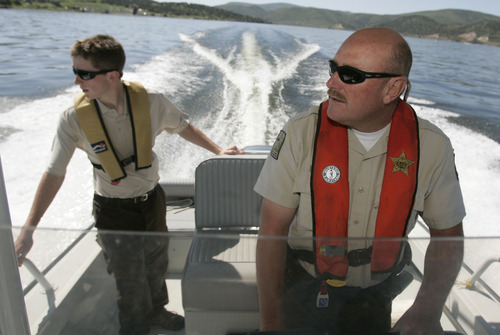 Tribune file photo
Utah State Parks boating director Dave Harris, right, and his son and volunteer Seth Harris patrol the waters in 2009 at Rockport Reservoir.