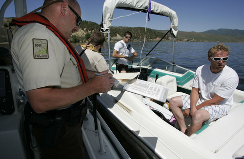 Tribune file photo
Utah State Parks boating director Dave Harris, left, issues a citation in 2009 at Rockport Reservoir.
