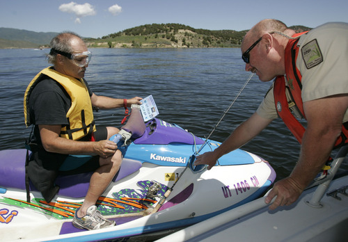 Tribune file photo
Utah State Parks boating director Dave Harris, right, talks to Jeff Kirby of Salt Lake City about the registration decal on his personal watercraft in this 2009 photo.