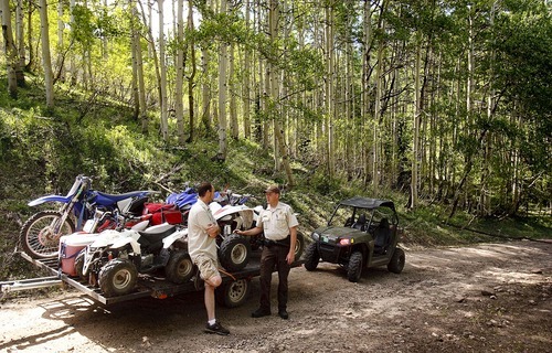 Trent Nelson  |  The Salt Lake Tribune
Ranger Drew Patterson, right, checks the registration of off-road vehicles in Wasatch Mountain State Park inMidway on Saturday, July 2, 2011. Shawn Horrocks is at left.