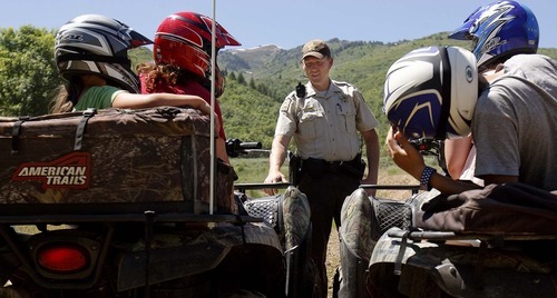 Trent Nelson  |  The Salt Lake Tribune
Ranger Drew Patterson compliments a group of riders on their use of helmets while patrolling Wasatch Mountain State Park in Midway on Saturday, July 2, 2011.