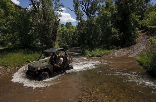 Trent Nelson  |  The Salt Lake Tribune
Ranger Drew Patterson drives through a creek while patrolling  Wasatch Mountain State Park in Midway on Saturday, July 2, 2011.