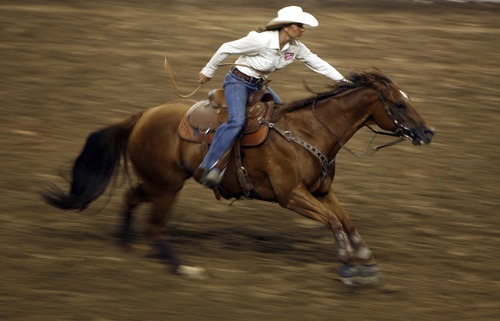 Trent Nelson  |  The Salt Lake Tribune
Kelli Tolbert of Hooper, Utah, in the Barrel Racing competition at the Days of 47 Rodeo, Maverik Center in West Valley City, Utah. Friday, July 22, 2011.