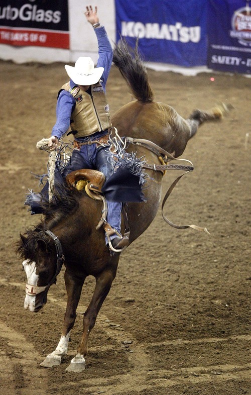 Trent Nelson  |  The Salt Lake Tribune
Brian Martinat of Marsing, Idaho, in the Saddle Bronc Riding competition at the Days of 47 Rodeo, Maverik Center in West Valley City, Utah. Friday, July 22, 2011.