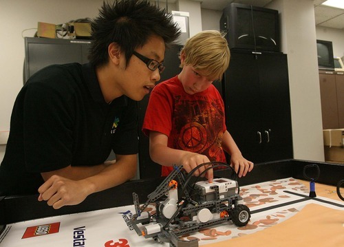 Leah Hogsten  |  The Salt Lake Tribune
Brian Larson, 11, gets help from GREAT instructor and computer science undergraduate Stephen Lu as the two work on creating robots during the University of Utah's GREAT summer camp on Friday at the Merrill Engineering Building.