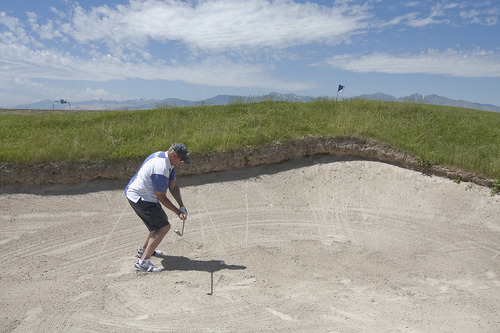 Margaret Distler  |  The Salt Lake Tribune

The Salt Lake Tribune sports writer Gordon Monson swings out of a sand trap on hole 3 at the Wingpointe Golf Course in Salt Lake City on Tuesday, June 28, 2011. Fellow sports writers Jay Drew and Kurt Kragthorpe joined Monson as they played the 18 toughest golf holes in Utah over the course of three days.