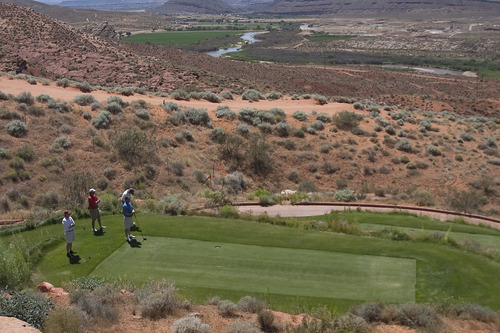 Margaret Distler  |  The Salt Lake Tribune

The Salt Lake Tribune sports writers Gordon Monson, Kurt Kragthorpe and Jay Drew survey hole 12 from the black tee box with one of the course staff members at the Sand Hollow Resort Golf Course in Hurricane on Monday, June 27, 2011. The three writers played the 18 toughest golf holes in Utah over the course of three days.