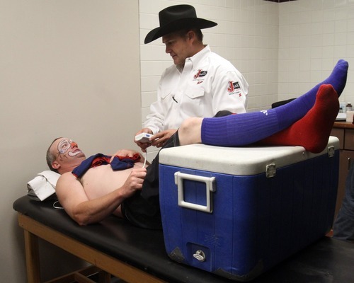 Rick Egan   |  The Salt Lake Tribune

Mike Stratton works on rodeo clown/bullfighter, Dustin Brewer before The Days of 47' Rodeo, at the Maverick Center, Wednesday, July 20, 2011