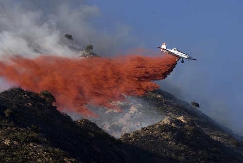 Tribune file photo
Fire retardant drops from aerial tankers, like this one during a recent wildfire near Salt Lake City, were credited Saturday for helping crews snuff the Saratoga Springs Fire in Utah County.