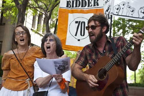 Chris Detrick | The Salt Lake Tribune 
Supporters of Tim DeChristopher, Krista Bowers, Joan Gregory and Miles Biddulph sing during a rally across from the Federal Courthouse in Salt Lake City on Tuesday, July 26, 2011. DeChristopher, the 29-year-old climate activist turned environmental folk hero, was sentenced Tuesday to spend two years in prison for disrupting a federal oil and gas lease auction, and fined $10,000.