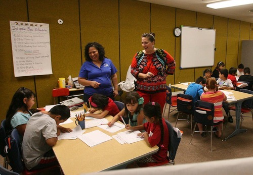 Leah Hogsten  |  The Salt Lake Tribune
Dee Elementary School third-grade teacher Elida Henriquez (left) and principal Sondra Jolovich-Motes giggle with summer school students as they work on short autobiographies Wednesday, July 20 2011, in Ogden.
Ogden School District faces challenges as a high-poverty school district. Students at Dee Elementary, a Title I school, attend summer classes to prepare for the upcoming school year.