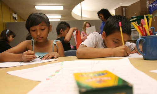 Leah Hogsten  |  The Salt Lake Tribune
Dee Elementary summer school students Giselle Andrade (left) and Isaac Banulas in third-grade teacher Elida Henriquez's class, work on their short autobiographies Wednesday, July 20 2011, in Ogden. Ogden School District faces challenges as a high-poverty school district. Students at Dee Elementary, a Title I school, attend summer classes to prepare for the upcoming school year.