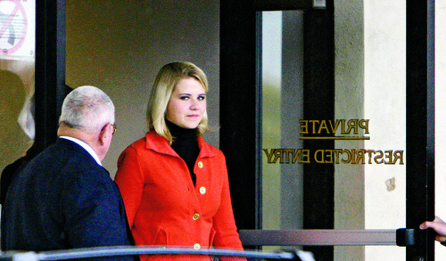 Steve Griffin  |  The Salt Lake Tribune

 Elizabeth Smart  leaves out  the back entrance of the Frank E. Moss Federal Courthouse in Salt Lake City Monday, November 8, 2010 after the first day of the trial for Elizabeth's suspected kidnapper, Brian David Mitchell.