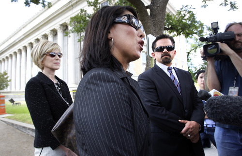Tony Gutierrez  |  The Associated Press

Attorney's Emily Munoz Detoto, center, Deric Walpole, right, and an unidentified member of the former defense team for polygamist leader Warren Jeffs talk with reporters in front of the Tom Green County Courthouse in San Angelo, Texas, on Thursday. Jeffs will represent himself at his sexual assault trial after dismissing his latest legal team, the seventh one, Thursday, just before his trial was to begin.
