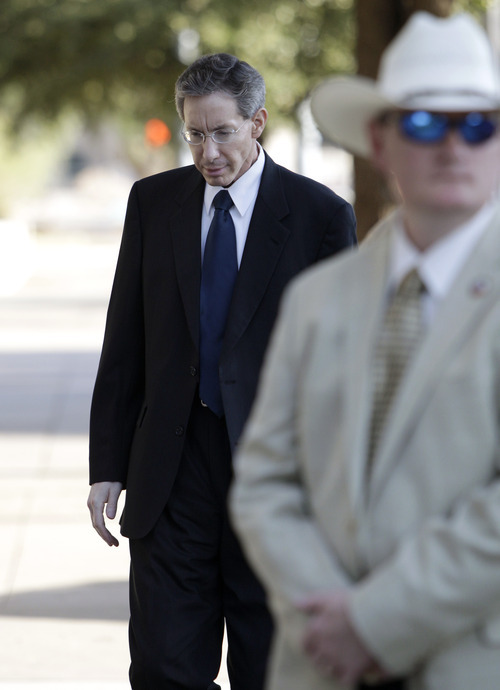 Tony Gutierrez  |  The Associated Press

A law enforcement official stands by as Polygamist sect leader Warren Jeffs, left, arrives at the Tom Green County Courthouse Thursday in San Angelo, Texas. Jeffs' much-anticipated Texas trial begins in earnest Thursday, with prosecutors claiming he sexually assaulted girls he manipulated into 