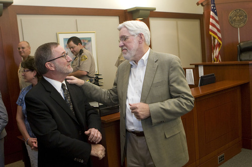 Al Hartmann   |  The Salt Lake Tribune 
Judge Robert Hilder, right, reminices with Daniel Becker, Utah court administrator, during a farewell party in his courtroom at the Matheson Courthouse Friday. Hilder is retiring after 17 years on the bench.