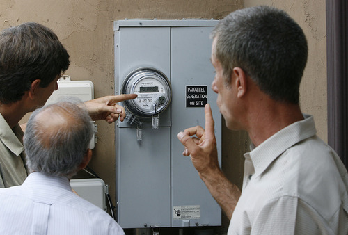 Scott Sommerdorf  |  The Salt Lake Tribune
Olympus Cove resident Bob Frey, right, and others look at his meter box on Saturday as they discuss the benefits of his newly-installed solar system. Frey has installed a solar energy system on his home and held an open house. He projects that with rebates, tax incentives and the sale of excess power, he will make an 8 percent return on his investment. The Park City company DwellTek installed the system.