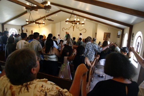 Tribune file photo by Chris Detrick
Family members of several trapped miners joined parishioners at Mission San Rafael Catholic Church in Huntington in saying the 'Our Father' at a Sunday Mass in which many prayers were offered for the safe return of the men.
