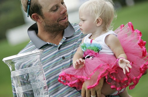 Djamila Grossman  |  The Salt Lake Tribune

J.J. Killeen looks at his daughter, Olivia, as he holds the trophy for winning the Utah Championship of the Nationwide Tour at Willow Creek Country Club in Sandy, Utah, on Sunday, July 31, 2011. Olivia turned 1 the same day.