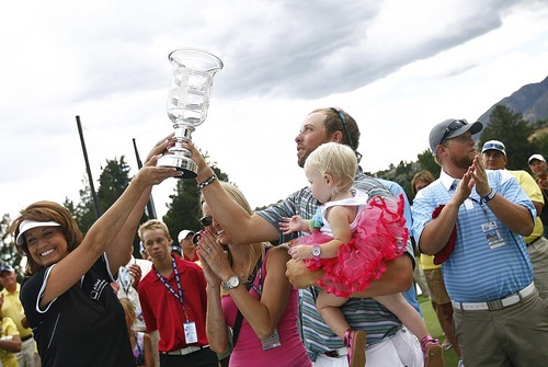 Djamila Grossman  |  The Salt Lake Tribune

J.J. Killeen holds his daughter, Olivia, as he receives the trophy for winning the Utah Championship of the Nationwide Tour at Willow Creek Country Club in Sandy, Utah, on Sunday, July 31, 2011.