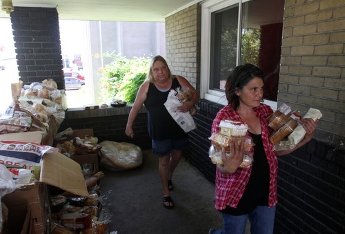 Rick Egan   |  The Salt Lake Tribune

Carrie Christensen, left, and Kathy Hills, of Rose Park, gather food from Shauna Devenport's front porch, Thursday, July 28, 2011. Devenport, the Bread Lady, has been distributing day-old bread, shoes and clothes from her front porch in Salt Lake City for nearly 20 years.
