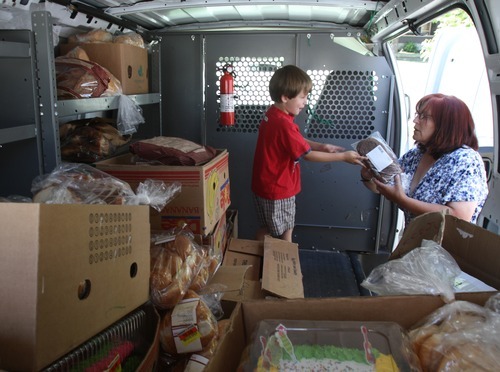 Rick Egan   |  The Salt Lake Tribune

Conner Nielsen, 5, helps his grandma, Shauna Devenport, unload bread from her van, Thursday, July 28, 2011. The Bread Lady, has been distributing day-old bread, shoes and clothes from her front porch in Salt Lake City for nearly 20 years. She collects food from grocery stores and bakeries from around the city.