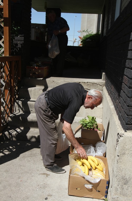 Rick Egan   |  The Salt Lake Tribune

Gregory Babiyan, from Armenia, gathers food from Shauna Devenport's front porch, Thursday, July 28, 2011. The Bread Lady, has been distributing day-old bread, shoes and clothes from her front porch in Salt Lake City for nearly 20 years. She collects food from grocery stores and bakeries from around the city.
