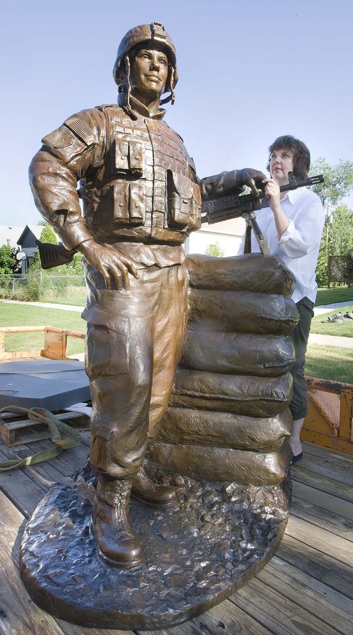 Paul Fraughton  |  The Salt Lake Tribune. Sculptor, Lena Toritch, stands next to her bronze statue of Spc. John Borbonus,  a soldier killed in Iraq in 2007.  The statue will be driven to Cascade, Idaho, the soldier's home town, to be placed in a park as a memorial.  Monday  August 1, 2011