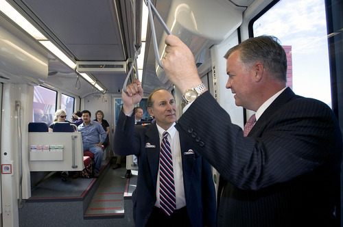 Al Hartmann  |  The Salt Lake Tribune
UTA General Manager Michael Allegra, left, talks to Salt Lake County Mayor Peter Corroon as a new stepless Trax train leaves the Daybreak Parkway Station after a ceremony Tuesday at Daybreak.   The train continued up the line to the West Valley Central Station. The new lines open for customers Sunday.