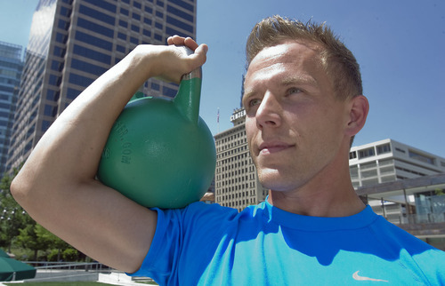 Al Hartmann  |  The Salt Lake Tribune 
Blake Robinson works out with a 45 pound kettle bell, a tool that went out of style but is making a comeback.  Swinging the bell with correct form works out the hamstrings, glutes, core, back and shoulder muscles.  Here he holds it in the 