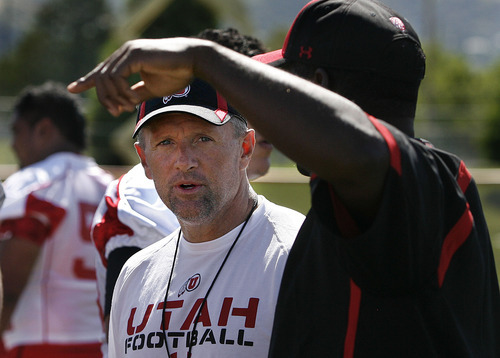 Scott Sommerdorf  |  The Salt Lake Tribune
Utha head coach Kyle Whittingham talks with a coach on his staff during practice on the Utah baseball field at the University of Utah Thursday, August 4, 2011.