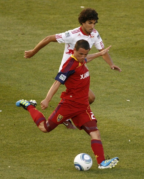 Trent Nelson  |  The Salt Lake Tribune
Real Salt Lake's Luis Gil scores a first half goal, with New York's Mehdi Ballouchy defending. Real Salt Lake vs. New York Red Bulls at Rio Tinto Stadium in Sandy, Utah. Saturday, August 6, 2011.