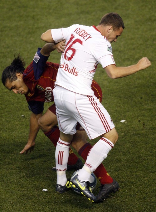 Trent Nelson  |  The Salt Lake Tribune
Real Salt Lake's Fabian Espindola and New York's John Rooney, front, compete for the ball. Real Salt Lake vs. New York Red Bulls at Rio Tinto Stadium in Sandy, Utah. Saturday, August 6, 2011. RSL wins 3-0.