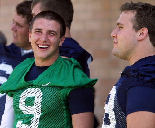 Rick Egan   |  The Salt Lake Tribune

 BYU QB, Jake Heaps (9) smiles as he chats with Houston Reynolds, before taking the field for the opening of Fall Football Camp at BYU, Saturday, August 6, 2011